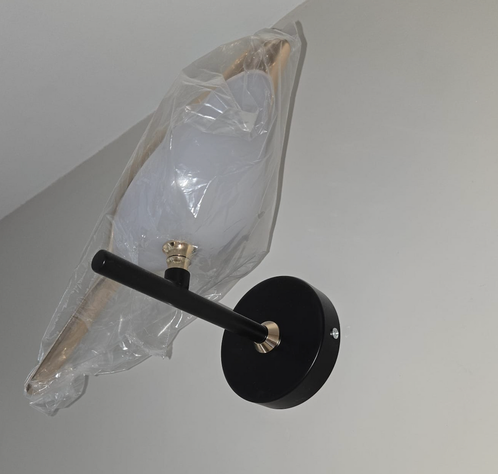 Bird wall lamp bottom-up view showing rotatable head