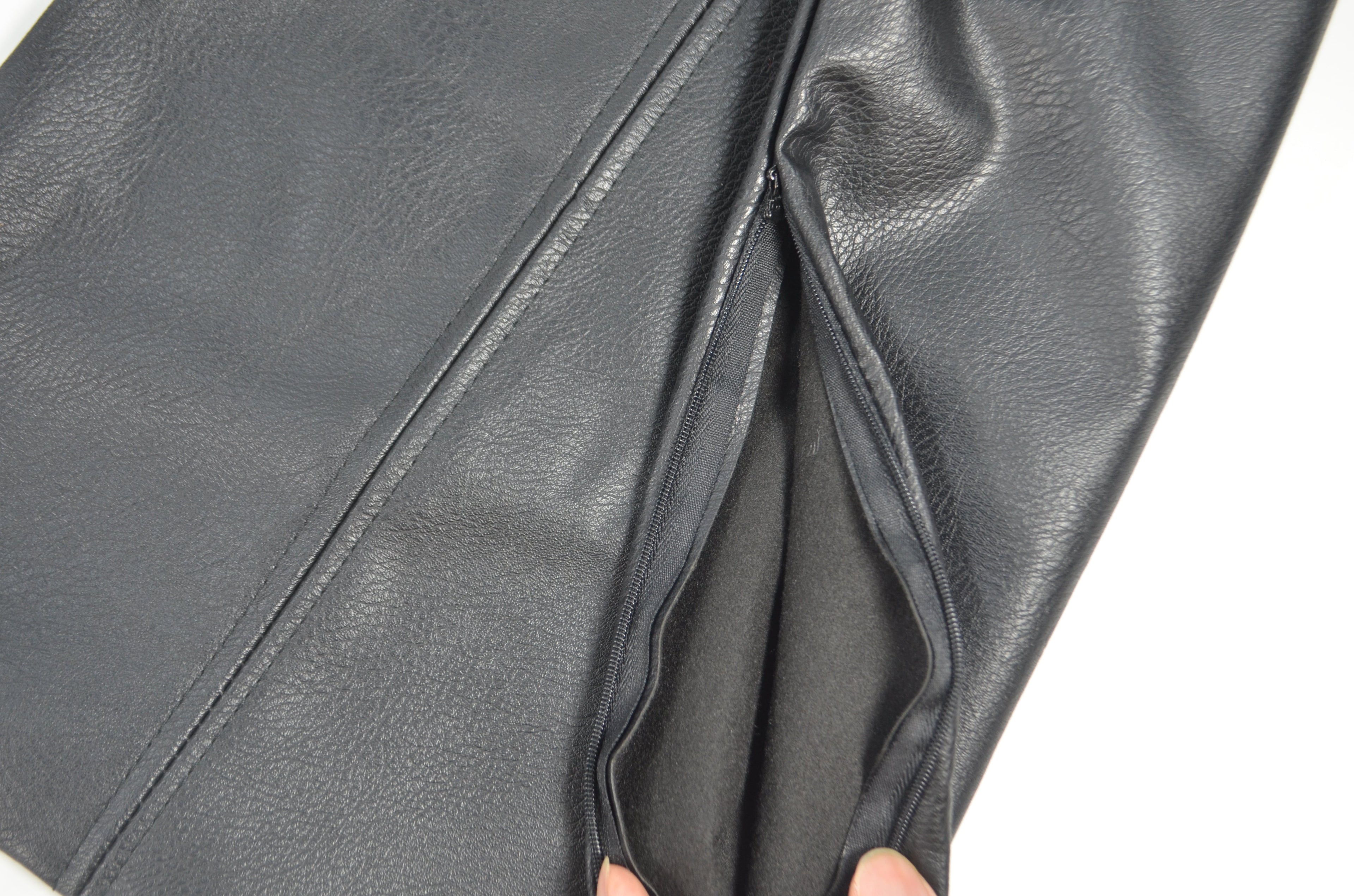 Black faux leather cushion covers styled on a sofa