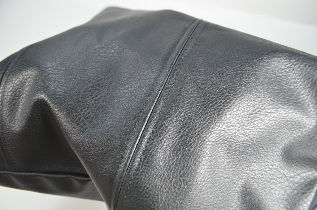 Close-up of black faux leather cushion cover texture