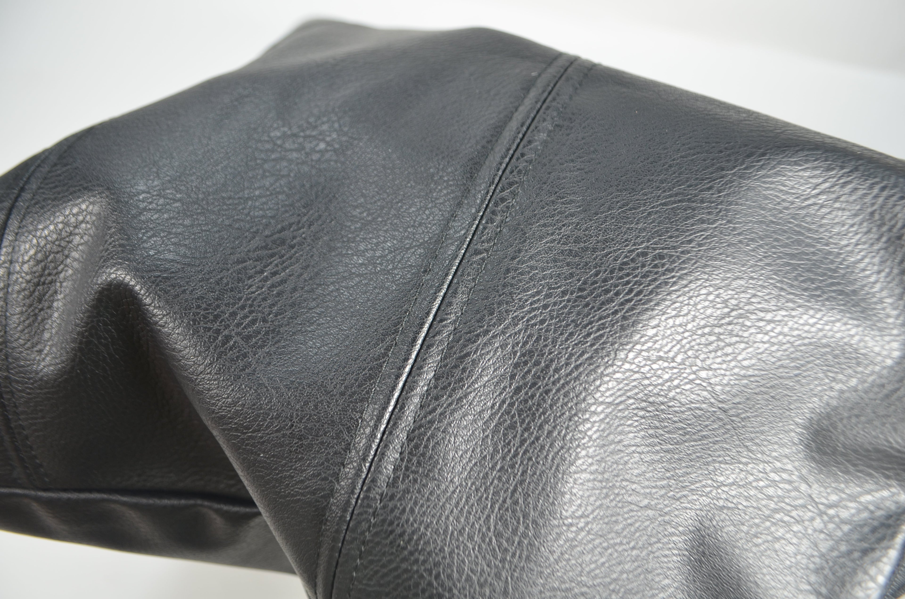 Close-up of black faux leather cushion cover texture