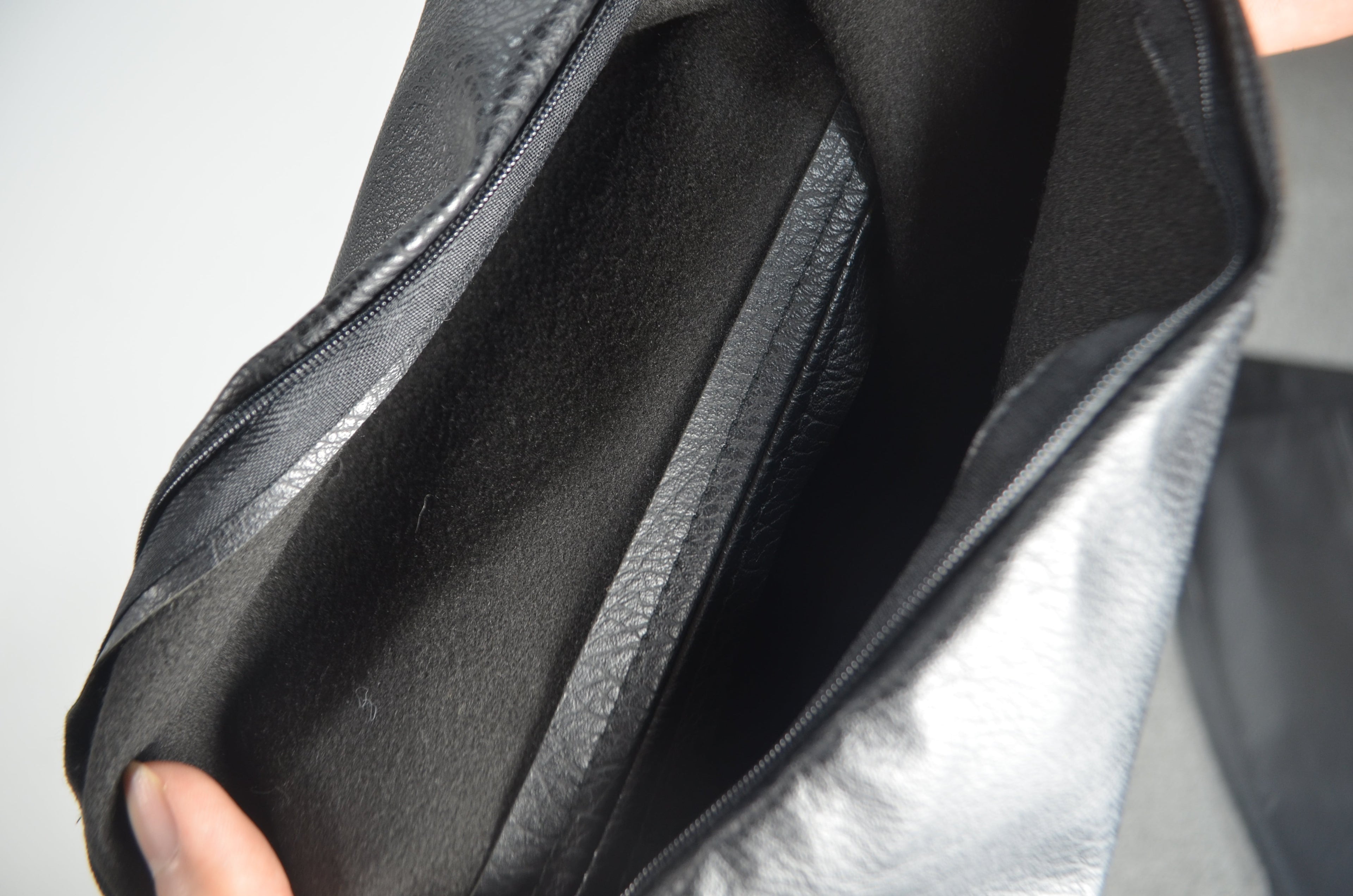 Black faux leather cushion covers styled on a bed