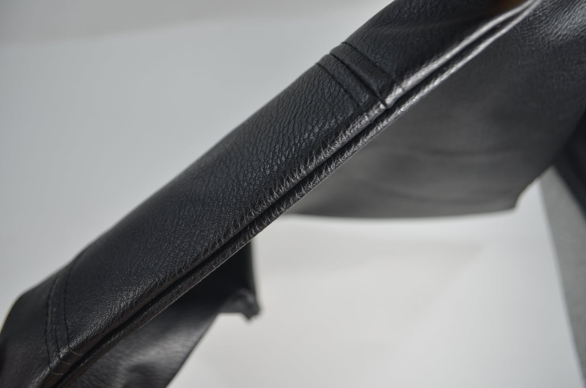 Hidden zipper detail on black faux leather cushion cover