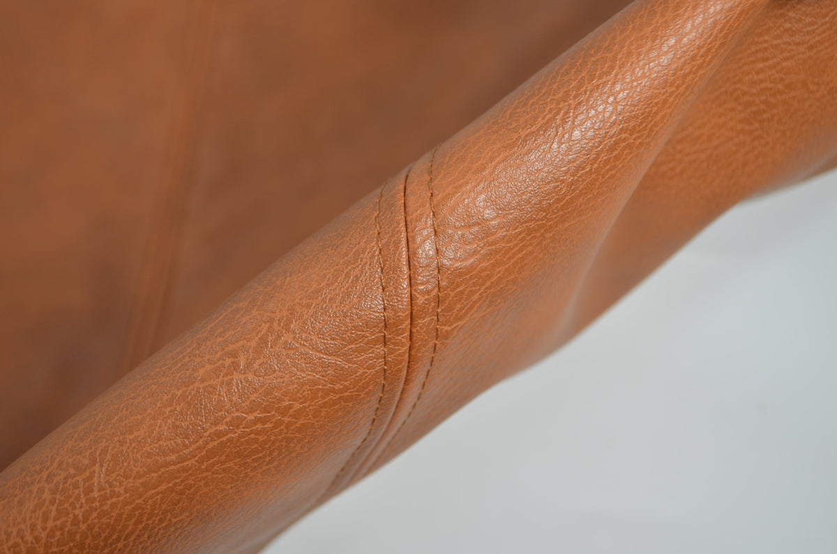 Brown checkered faux leather cushion covers styled on a sofa