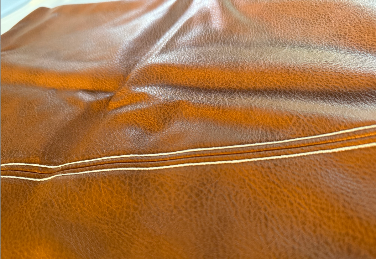Milan diagonal faux leather cushion covers styled on a sofa