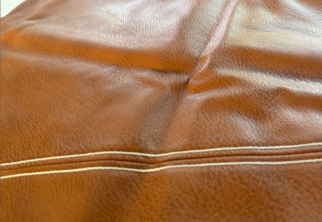 Milan diagonal faux leather cushion covers styled on a bed