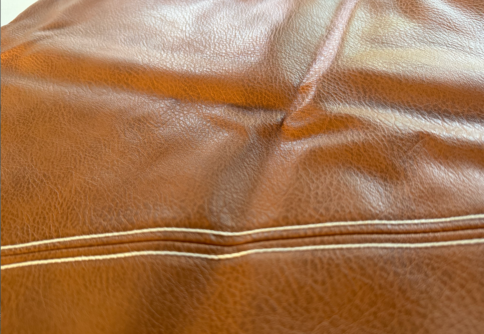 Milan diagonal faux leather cushion covers styled on a bed